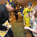 The Huber family, of Farmington Hills, watches as Fab Fiver Jimmy King autographs their sign after the Michigan Alumni Association pep rally at the Renaissance Atlanta Waverly Hotel in Atlanta on Friday, April 5, 2015. Melanie Maxwell I AnnArbor.com